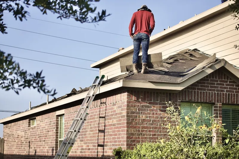 Professional roofer working on a residential roof in Woodsburgh